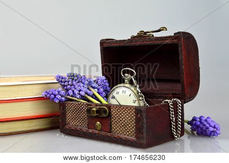 Pocket watch and flowers in the treasure chest