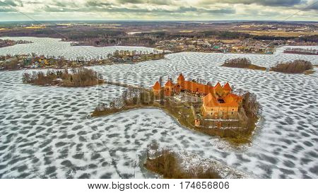 Trakai, Lithuania: aerial winter UAV top view, flat lay of gothic Island Castle and city of Trakai in the winter