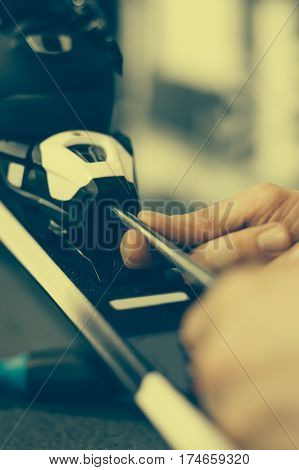 Ski Repair Shop Worker Adjust The Bindings