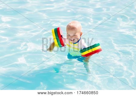 Little Baby Boy Playing In Swimming Pool