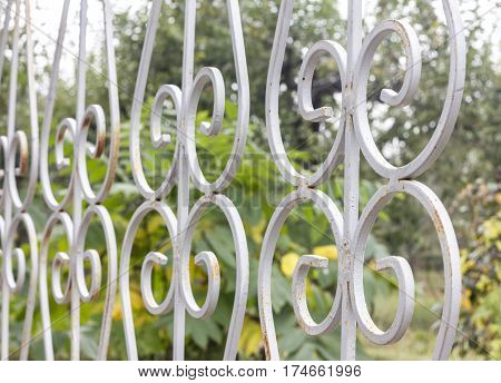 Old rusty iron fence grey color close-up. Abstract cover. Abstract background