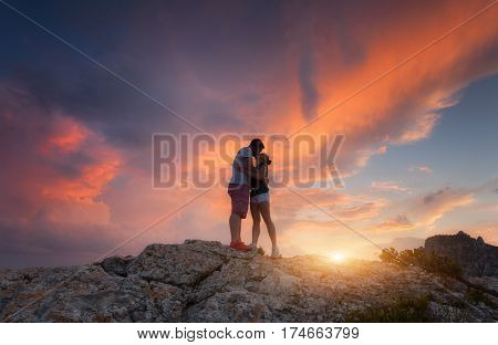 Silhouettes Of A Hugging And Kissing Man And Woman