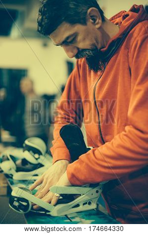 Snowboard Repair Shop Worker Adjust The Bindings
