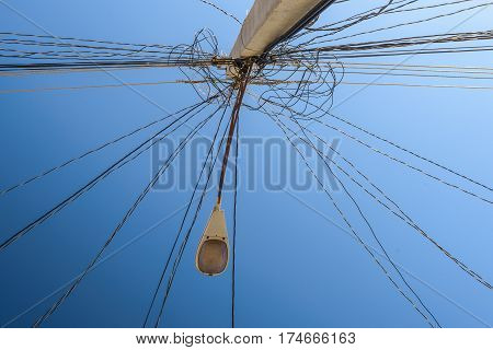 Electric pole against blue sky in Trinidad Cuba.