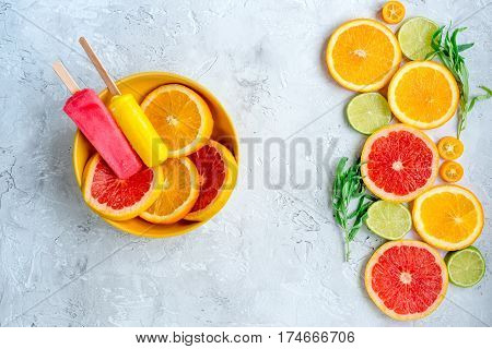 Homemade orange icecream with fresh fruits on stone table background top view mock-up