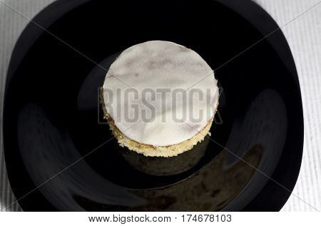 Homemade butter white cake on a black plate