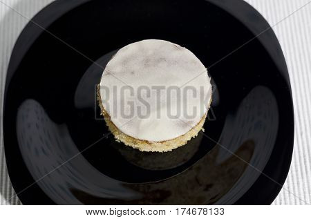 Homemade butter white cake on a black plate