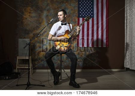 Moscow, Russia - Mart 03, 2017: Young rock musician with a vintage electric guitar Gibson es-345 1969 model year