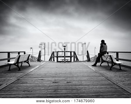 Man On Long Touristic Mole, Autumn Cold Morning. Tourist At Handrail.
