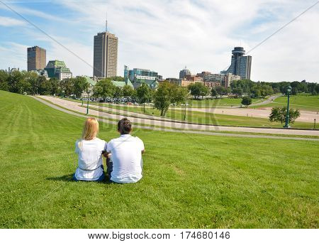 Man and woman looking at old Quebec City. National Battlefields Park.