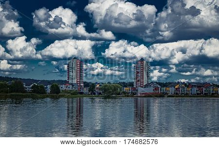 Modern architecture in Sweden with a cloudy sky. Pyramid greenhouses on the roof of the tall buildings.