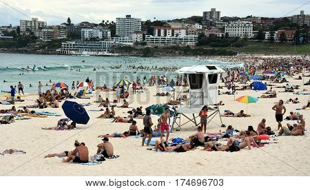 Sydney Australia - Feb 5 2017. People relaxing swimming and sun bathing on Bondi beach. Bondi beach is one of the most famous tourist sites in Australia.