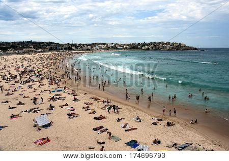 Sydney Australia - Feb 5 2017. People relaxing swimming and sun bathing on Bondi beach. Bondi beach is one of the most famous tourist sites in Australia.
