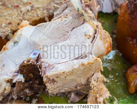 Juicy pork meat cooked for lunch. Sliced pork barbecue with pink meat. Spanish dish lechon close image for restaurant menu or eatery illustration. Tasty meat ready for eat. Traditional spanish cuisine