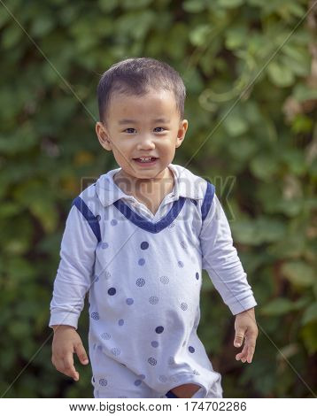 asian adorable children toothy smiling face happiness emotion outdoor portrait