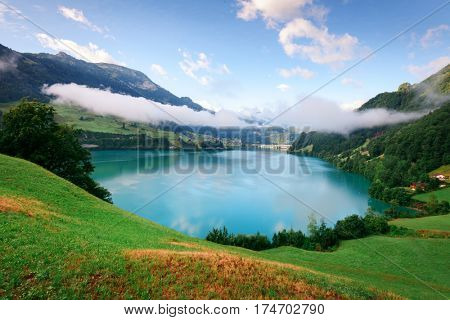Amazing view of the Lungerersee lake in the morning mist. Lungern village, Switzerland, Europe.