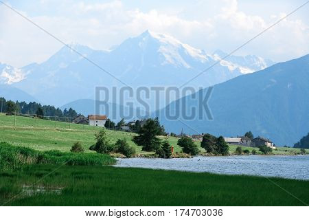 Beautiful view of the lake Muta (Haidersee) and Ortler peak, located near the village St. Valentin, Alps, Italy, Europe.