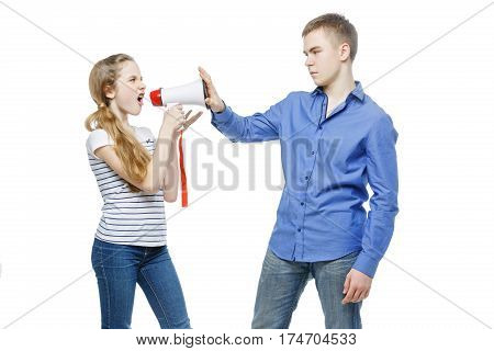 Teen age girl screaming at boy through megaphone. Brother and sister isolated on white background. Copy space.