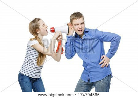 Teen age girl screaming at boy through megaphone. Brother and sister isolated on white background. Copy space.