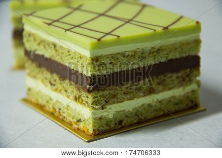 A pistacho layer cake and chocolate garnache