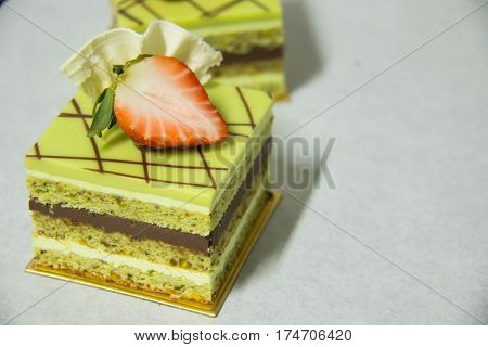 A pistacho layer cake and chocolate garnache