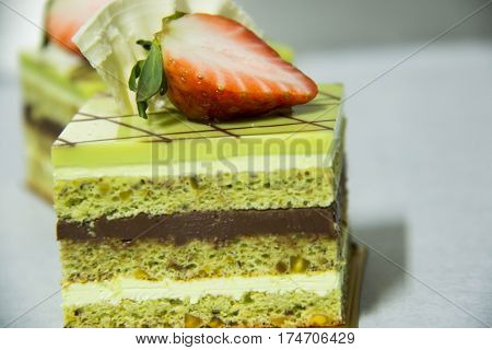 A pistacho layer cake and chocolate garnache