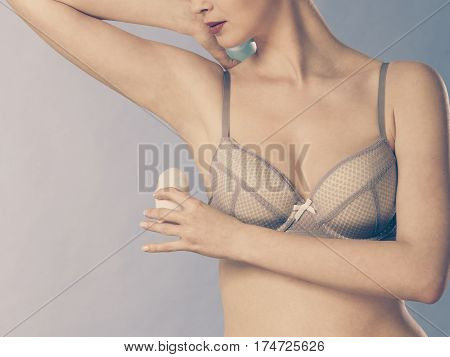 Girl Applying Stick Deodorant In Armpit