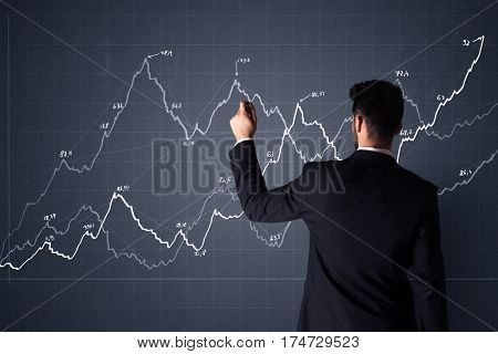 Young businessman in black suit standing in front of a progress chart
