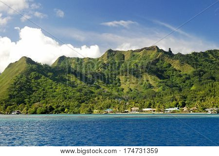 View on Mount Otemanu through turquoise lagoon, palms, and overwater bungalows on the tropical island Bora Bora, honeymoon destination, near Tahiti, French Polynesia, Pacific ocean.HDR picture.