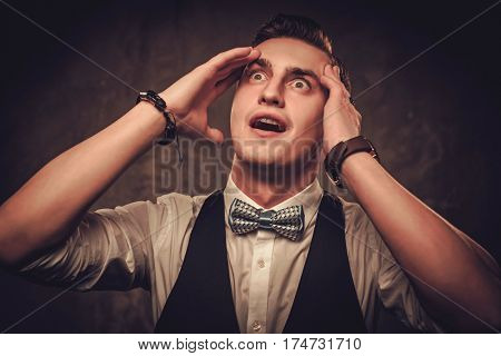 Sharp dressed man wearing bow tie showing emotions.