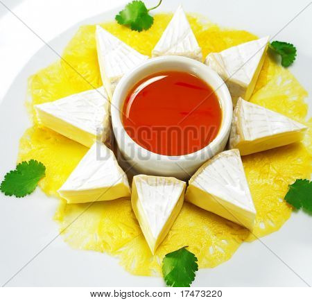 Fromage (Soft Cheese) with Honey Orange Sauce and Fresh Pineapple. Isolated on White Background