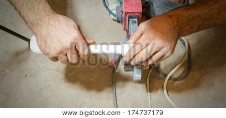 Plumber Weld Two Pieces Of White Polypropylene Pipes