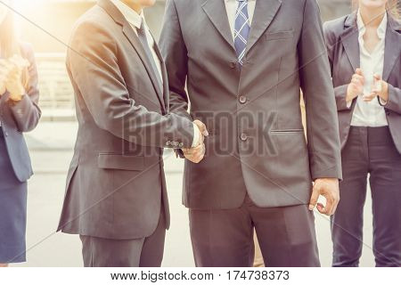 Success and Happiness concept Business man handshake at city outside office.