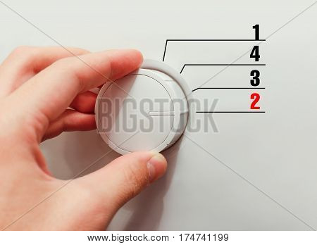 Male Hand Turns The Switch. Switches Figures. Chose The Number 2.