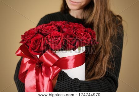 Girl In Black Jacket Holding In Hand Rich Gift Bouquet Of 21 Red Roses. Composition Of Flowers In A