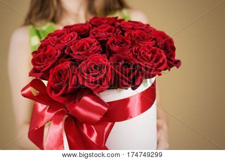 Girl Holding In Hand Rich Gift Bouquet Of 21 Red Roses. Composition Of Flowers In A White Hatbox. Ti