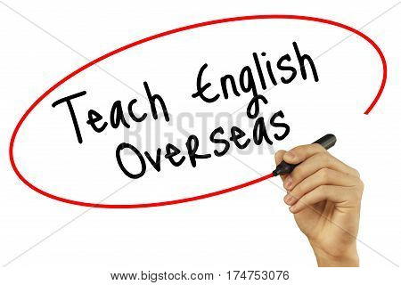 Man Hand Writing Teach English Overseas With Black Marker On Visual Screen. Isolated On Background.