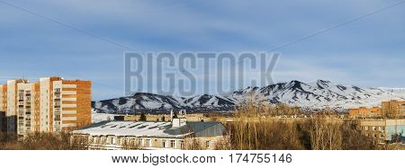 Apartment buildings, small town, cityscape, big mountain