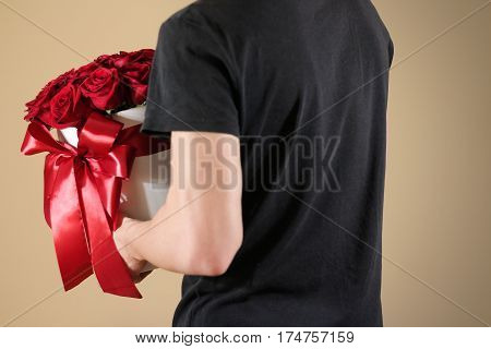 Man In Black T Shirt Holding In Hand Rich Gift Bouquet Of 21 Red Roses. Composition Of Flowers In A