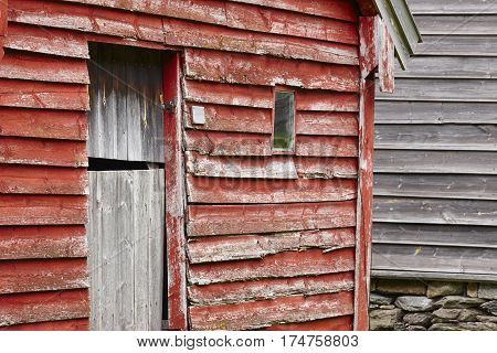 Traditional norwegian wooden red colored cabin houses facades. Otternes Norway