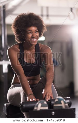 young fit african american woman doing sit ups in fitness studio at the gym.Abdominal exercises Sit up