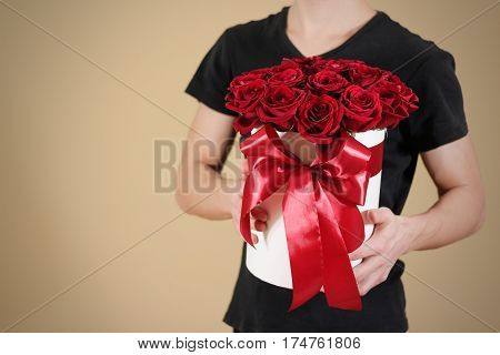 Man In Black T Shirt Holding In Hand Rich Gift Bouquet Of 21 Red Roses. Composition Of Flowers In A