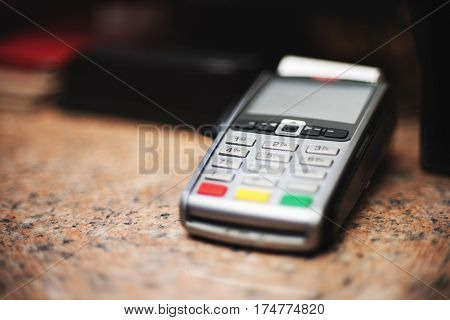 Close Up Of Credit Card Reader And Cash Register On Background Of Retail Shelves