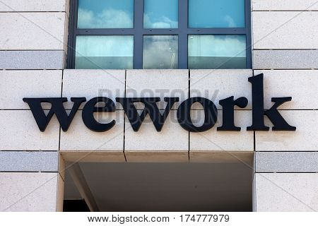 Tel Aviv, Israel - March 4, 2017: WeWork sign. WeWork is an American company which provides shared workspace, community, and services for entrepreneurs, freelancers, startups and small businesses.