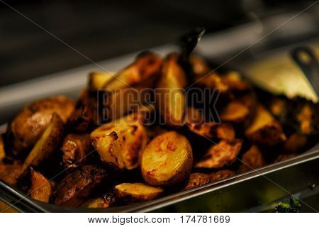 Fried potatoes with bacon and onions in pot.
