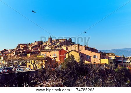 Military aircraft flying over the Roussillon village. One of the most impressive villages in France