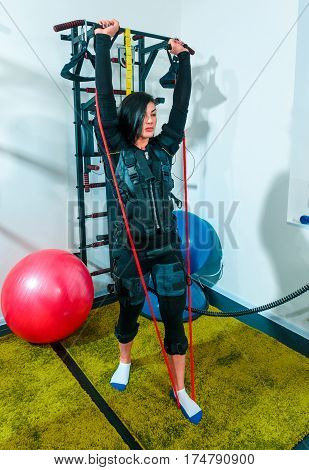 The female athlete doing they exercise in the EMS fitness studio