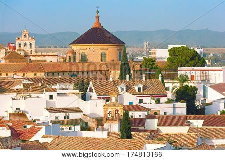 Roof of the old city and church Iglesia del Colegio de Santa Victoria, aerial view from the bell tower at the Mezquita in Cordoba, Andalusia, Spain