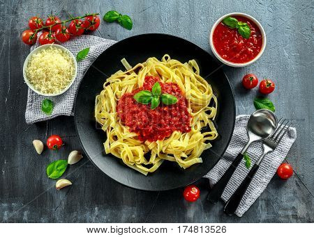 Homemade Hot Pasta with Marinara Sauce, Basil, Garlic, Tomatoes, parmesan cheese on plate