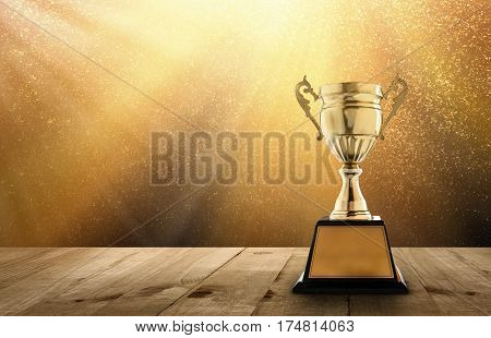 champion golden trophy on wood table with copy space and gold Twinkly Lights and glitter stars light background copy space ready for your design.